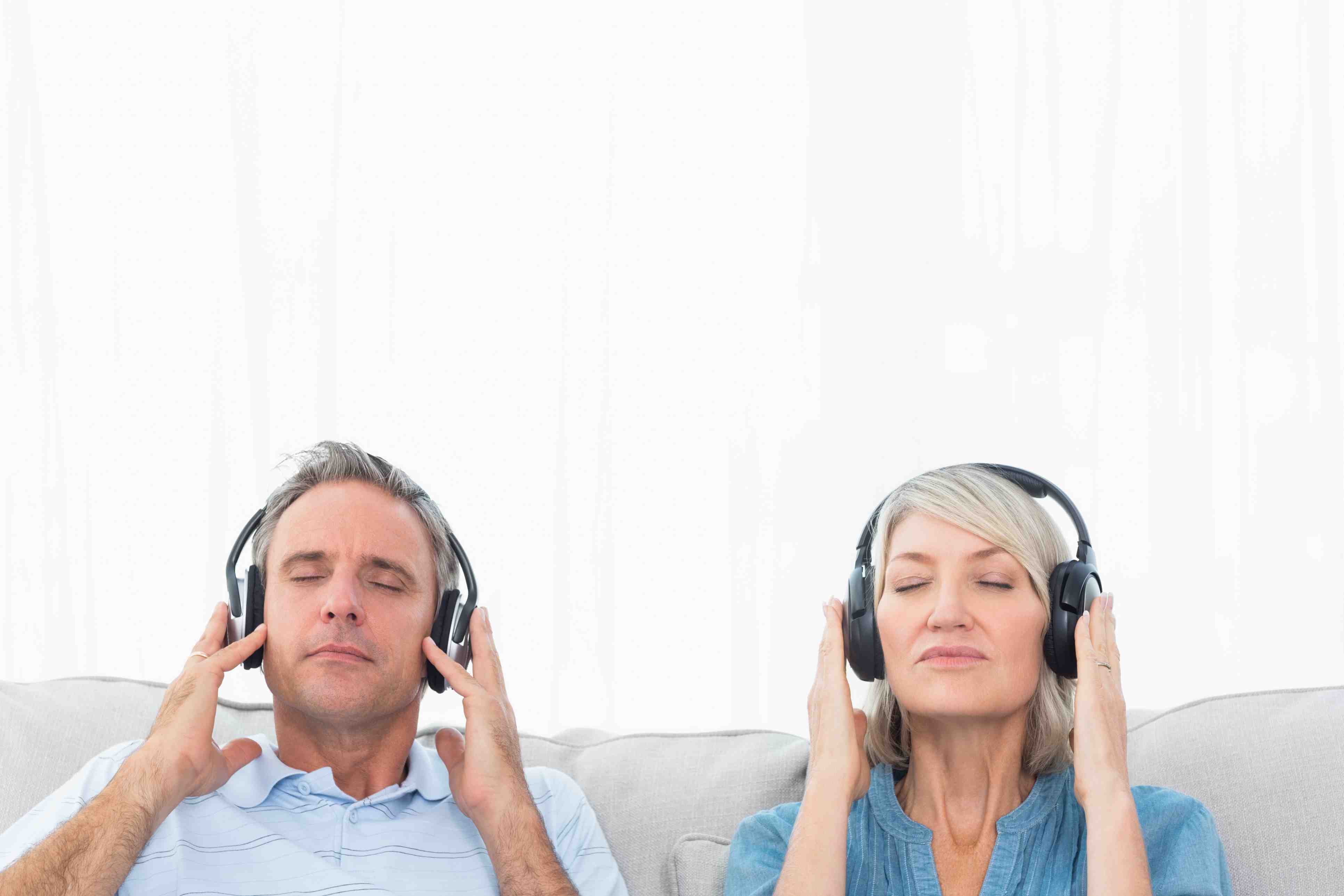 couple listening to music together couch 179694954 – CROP